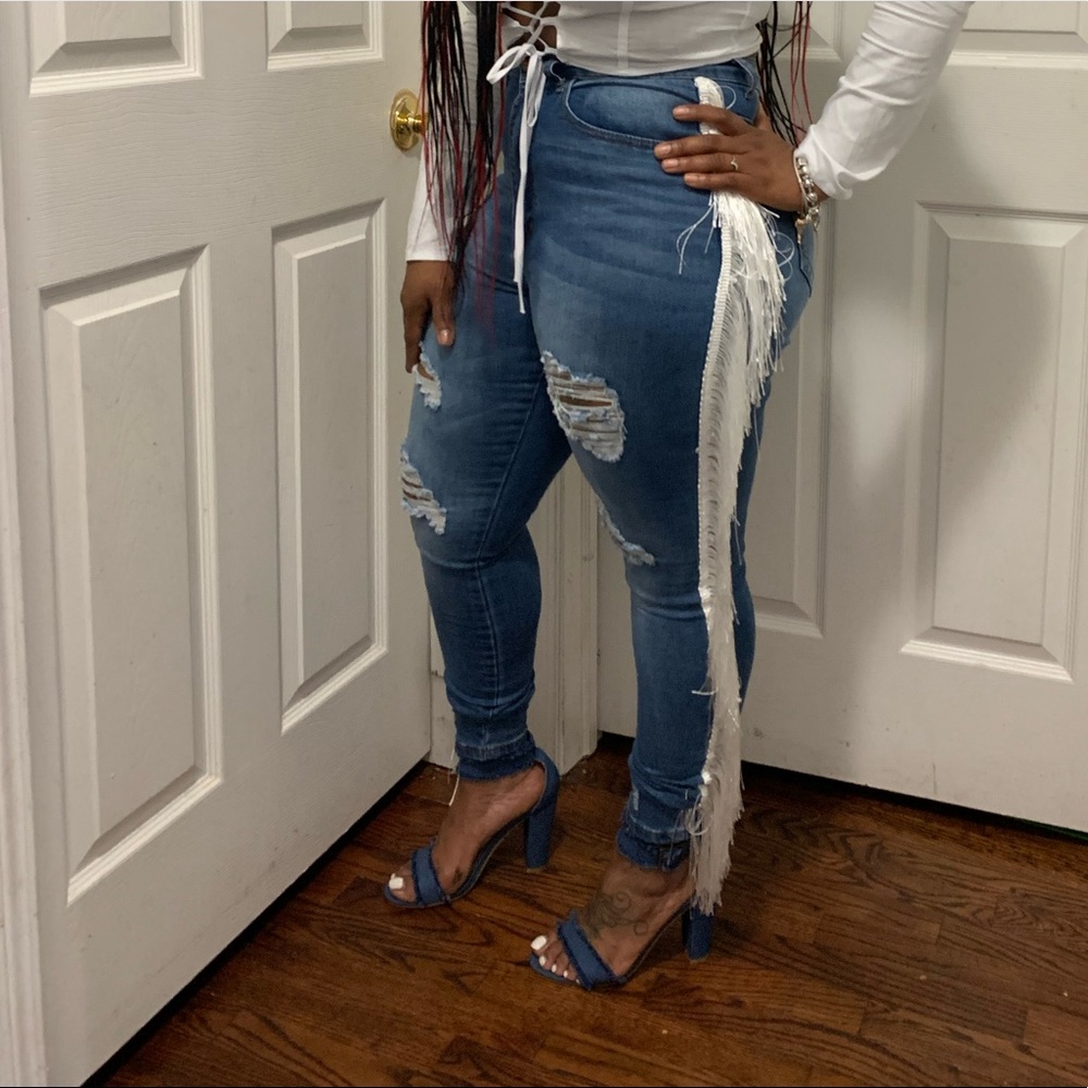 Blue jeans with white fringe along the side. Worn once